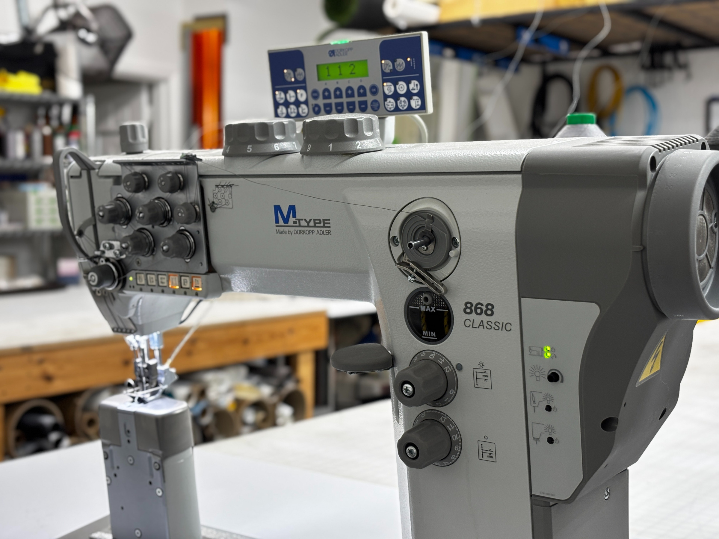 Sewing marine canvas in workshop